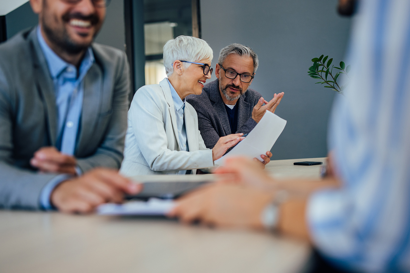 People having a meeting, focus on two mature colleagues