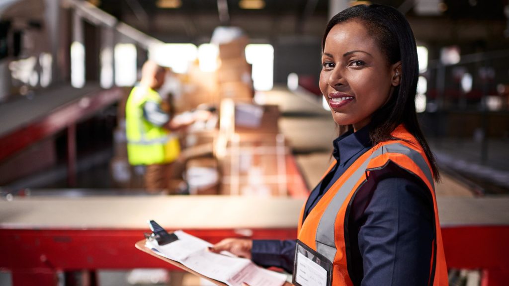 Woman in hi-vis vest with clipboard